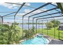 Screened pool overlooks lush backyard and serene lake, offering the perfect oasis at 14819 Braywood Trl, Orlando, FL 32824
