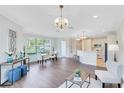 Spacious and bright living room with hardwood floors, chandelier lighting, and a view of the outdoors at 1565 Corkery Ct, Winter Springs, FL 32708