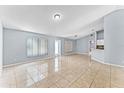 Bright, open living room with tile floors, neutral walls, and plenty of space for entertaining and relaxation at 1802 Hagen Ct, St Cloud, FL 34771