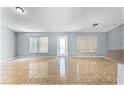 Bright living area with tile flooring and large windows bringing in natural light, located near the kitchen area at 1802 Hagen Ct, St Cloud, FL 34771