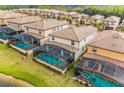 Aerial view of several private screened pools with sparkling water, perfect for relaxation and entertainment at 1864 Nice Ct, Kissimmee, FL 34747