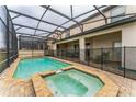Inviting screened-in pool and spa offer a relaxing retreat, with a safety fence for added security at 1864 Nice Ct, Kissimmee, FL 34747