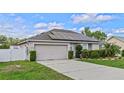 Single Gathering home featuring solar panels and landscaped front yard with a well-maintained lawn and two-car garage at 1942 N Portillo Dr, Deltona, FL 32738