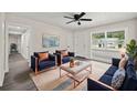 Bright living room featuring modern furniture, decor, ceiling fan, and gray-toned wood floors at 2015 N Hastings St, Orlando, FL 32808