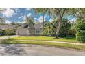 Charming single-Gathering home featuring a paver driveway, attached garage, and lush landscaping at 203 Red Bud Ct, Lake Mary, FL 32746