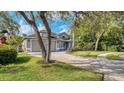 Charming single-Gathering home featuring a paver driveway, attached garage, and lush landscaping at 203 Red Bud Ct, Lake Mary, FL 32746