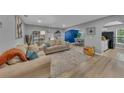 Bright and spacious living room with neutral tones, hardwood floors, and comfortable seating arrangement at 2914 Clarabelle Ct, Kissimmee, FL 34743
