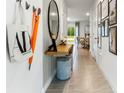 Stylish entryway featuring tile floors, a decorative mirror, and a view into the dining area at 2915 Canary Ave, Davenport, FL 33837