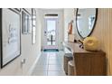 Bright entryway with decor, tile flooring, a wooden console table, and front door views at 2915 Canary Ave, Davenport, FL 33837