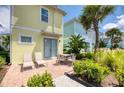 Cozy outdoor patio with brick pavers, seating, manicured garden, and tropical landscaping at 2978 Latitude Ln, Kissimmee, FL 34747
