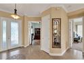 Bright and spacious foyer with tile flooring and decorative mirror at 313 Sorrento Rd, Poinciana, FL 34759