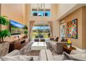 Bright living room featuring soaring ceilings, plush seating, and a view of the outdoors at 3228 Brasilia Ave, Kissimmee, FL 34747