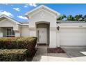 Inviting front entrance of home showing the front door, and a two-car garage at 3536 Moss Pointe Pl, Lake Mary, FL 32746