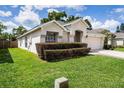 Beautiful home with manicured lawn, trimmed bushes, and a driveway leading to the garage at 3536 Moss Pointe Pl, Lake Mary, FL 32746
