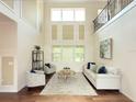 Bright living room with soaring ceilings, large windows, and elegant decor at 4120 Juliana Lake Dr, Auburndale, FL 33823