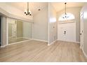Open foyer featuring tile floors, high ceilings, modern chandelier and sidelight window at 4404 Gwyndale Ct, Orlando, FL 32837