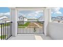 Balcony view of a neighborhood with pond and other homes from outdoor balcony at 5260 Citrus Leaf Blvd, Winter Garden, FL 34787