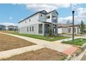 A charming two-story home featuring a two-car garage, a balcony, and an adjacent lawn at 5260 Citrus Leaf Blvd, Winter Garden, FL 34787