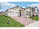 Inviting single-Gathering home featuring a covered front porch and two-car garage, and landscaped front yard at 5290 Citrus Leaf Blvd, Winter Garden, FL 34787