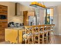 Bright kitchen features a large island with seating, stainless steel appliances, and modern lighting fixtures at 7513 Brooklyn Dr, Kissimmee, FL 34747