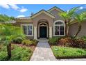 Inviting home entrance featuring stately columns and lush landscaping at 7672 Torino Ct, Orlando, FL 32835