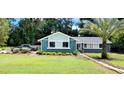 Single-story home with fresh landscaping and a healthy palm tree in the front yard at 811 Fairview Ave, Altamonte Springs, FL 32701
