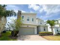 Charming two-story home with a stone facade, a gray garage door, and a well-kept lawn at 8912 Cabot Cliffs Dr, Davenport, FL 33896