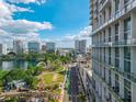 Stunning city view with a park and lake under a bright sky and a building at 150 E Robinson St # 409, Orlando, FL 32801