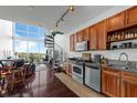 Modern kitchen with stainless steel appliances, granite countertops, and a spiral staircase to an upper level at 150 E Robinson St # 409, Orlando, FL 32801