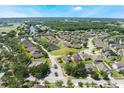 Beautiful aerial view of a community with well-manicured lawns, mature trees, and stunning waterways at 1920 Commander Way, Kissimmee, FL 34746