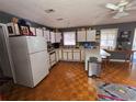 A spacious kitchen with white cabinets, updated appliances, and a functional layout with an island at 247 S Marydell Ave, Deland, FL 32720
