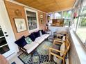 Bright sunroom with stylish furnishings, lots of natural light, and views of the surrounding greenery at 247 S Marydell Ave, Deland, FL 32720