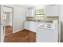 Cozy kitchen with white cabinets, laminate countertops, and a white electric range oven at 2827 Sanka Dr, Orlando, FL 32826