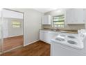 Cozy kitchen with white cabinets, laminate countertops, and a white electric range oven at 2827 Sanka Dr, Orlando, FL 32826