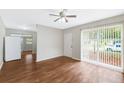 Bright living room featuring wood floors, a ceiling fan, and sliding glass doors that bring in natural light at 2827 Sanka Dr, Orlando, FL 32826