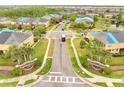 Aerial view showcases a residential community's street, sidewalks, landscaping, signage, and well-maintained homes at 3166 Rodrick Cir, Orlando, FL 32824