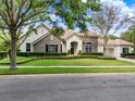 Beautiful single Gathering home with stone accents, manicured lawn, arched entry and a three car garage at 32613 View Haven Ln, Sorrento, FL 32776