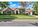 Beautiful single Gathering home with stone accents, manicured lawn, arched entry and a three car garage at 32613 View Haven Ln, Sorrento, FL 32776