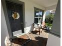 Charming front porch seating area with comfortable chairs and a welcoming doormat at 3399 Buoy Cir, Winter Garden, FL 34787