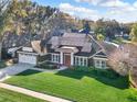 A bird's eye view of a home featuring solar panels, lush landscaping, and a well-maintained lawn at 4916 Winwood Way, Orlando, FL 32819