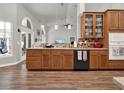 Cozy kitchen features wooden cabinets, granite countertops, stainless steel appliances, and views to the backyard at 4916 Winwood Way, Orlando, FL 32819