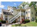 Two-story condo with white stairs and well-maintained landscaping at 5005 Laguna Bay Cir # 17, Kissimmee, FL 34746