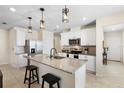 Stylish kitchen with white cabinetry, granite countertops, stainless steel appliances, and seating at the island at 5298 Royal Point Ave, Kissimmee, FL 34746