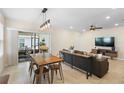 Open-concept living area with tile flooring, modern lighting, and seamless access to the outdoor patio at 5298 Royal Point Ave, Kissimmee, FL 34746