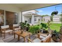 Cozy covered patio featuring stylish outdoor furniture and lush greenery, perfect for relaxing at 5298 Royal Point Ave, Kissimmee, FL 34746