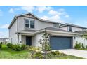 Attractive home featuring a two-car garage and welcoming landscaping, enhancing its street presence at 5329 Royal Point Ave, Kissimmee, FL 34746