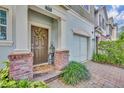 Close-up of a cozy front porch with brick accents and stylish decor at 58 Zamora Pl, Oviedo, FL 32765