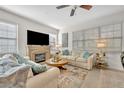 Bright living room features a fireplace, ceiling fan, and neutral decor at 58 Zamora Pl, Oviedo, FL 32765