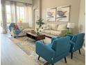 Spacious living room with comfortable seating, a stylish rug and natural light at 8023 King Palm Cir, Kissimmee, FL 34747