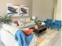Bright living room featuring stylish seating, neutral walls, and modern art at 8023 King Palm Cir, Kissimmee, FL 34747